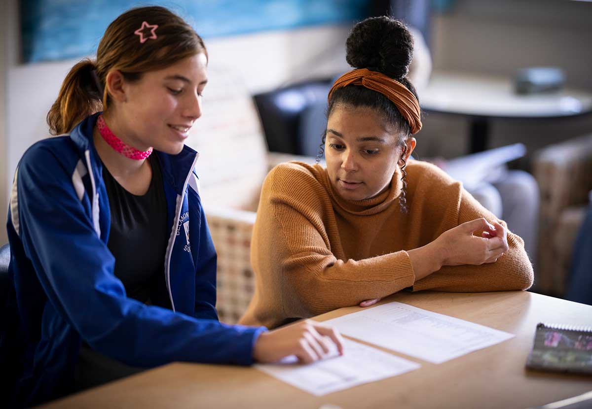 A student and teacher discuss a social studies topic