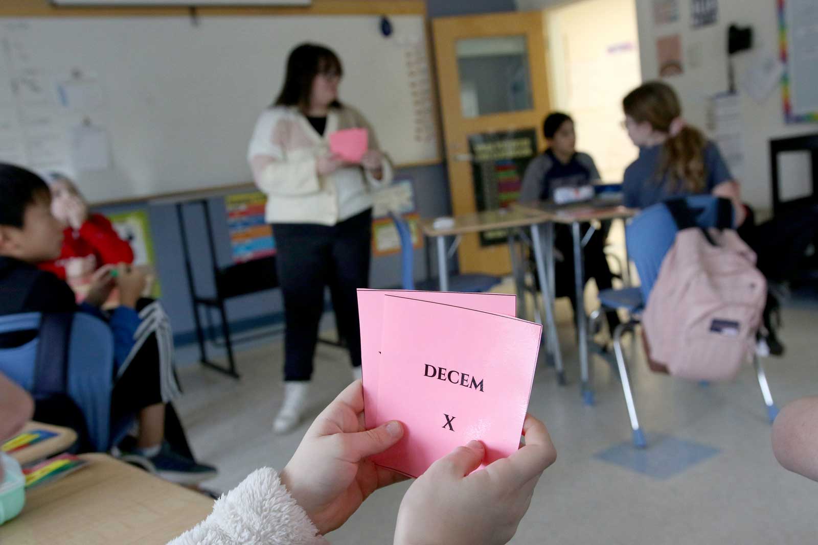 A student holds up a flash card in Latin class