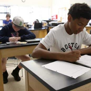 Student Taking Notes in Seventh Grade Science Class at Belmont Day School