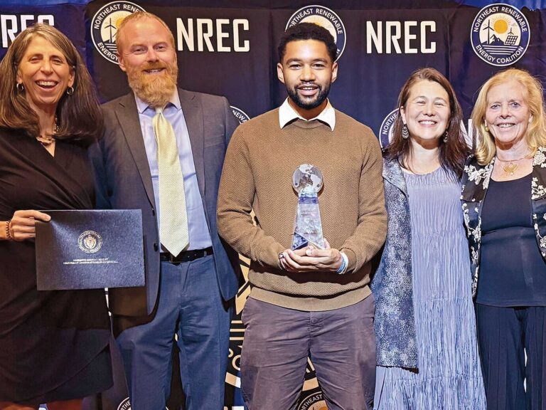 Eric Juma with HEET colleagues accepting an award
