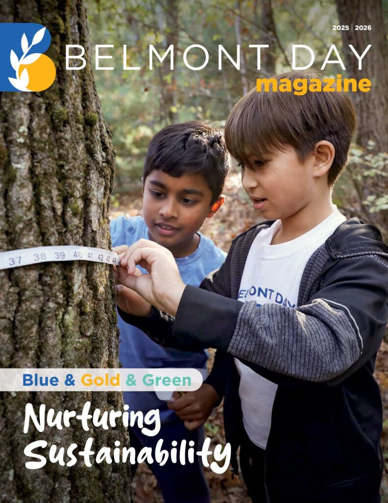 Two young students measure the diameter of a tree on campus